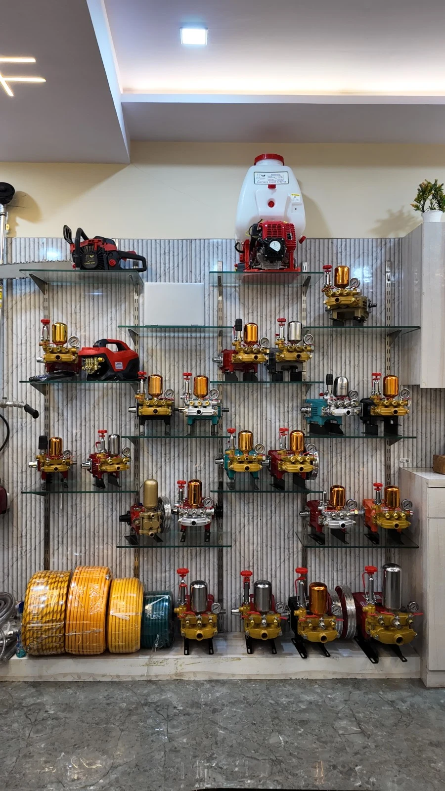 J.P Agro Industries (India) showroom display of HTP pumps, sprayers and spray hose, view 1