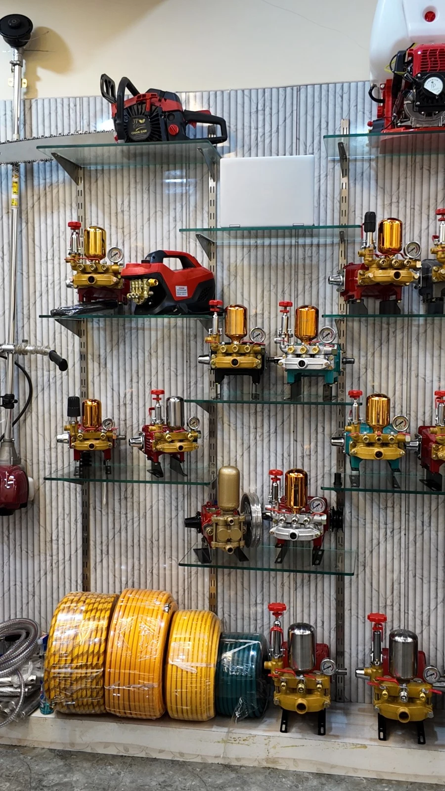 J.P Agro Industries (India) showroom display of HTP pumps, sprayers and spray hose, view 2